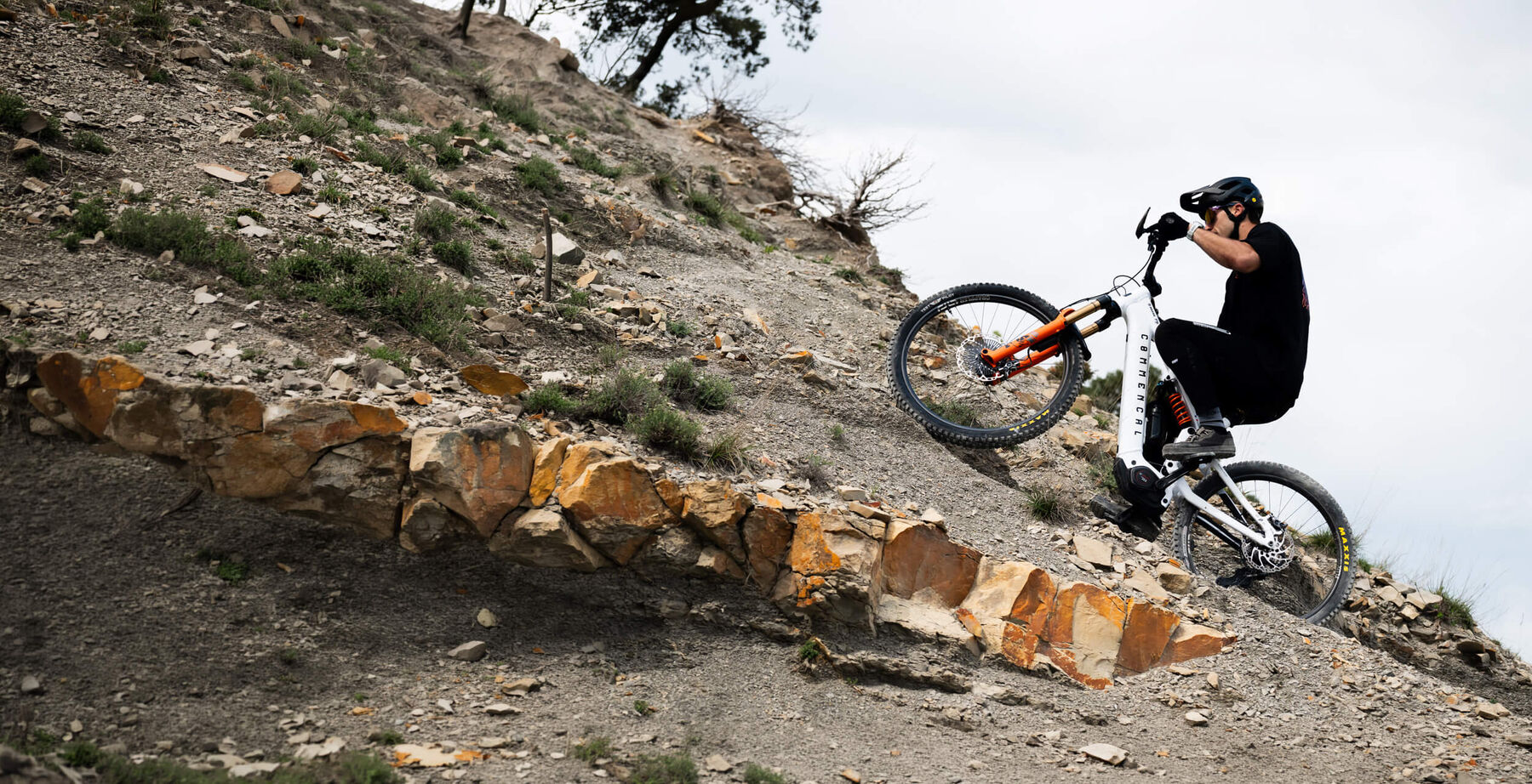 COMMENCAL rider tackling a rocky climb